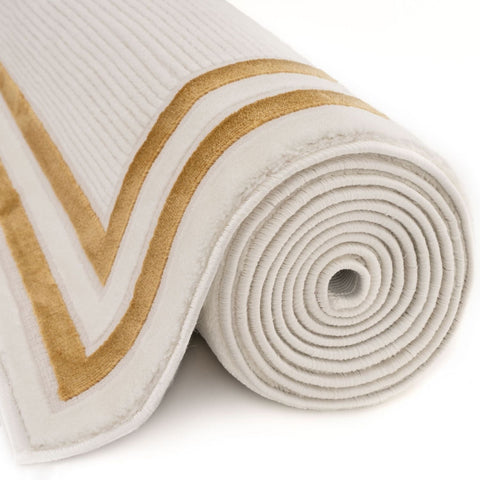 A plush off-white bordered rug with ribbed texture and gold geometric stripes perfect for stylish spaces