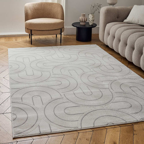 A light gray geometric rug with subtle embossed interlocking curved lines carmel cream-grey 6070