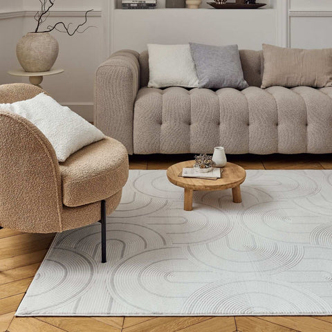 A light gray geometric rug with a subtle swirling pattern in darker gray perfect for living rooms