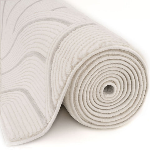 A plush carmel cream grey geometric rug with a soft looped pile and textured wave pattern bath mat design