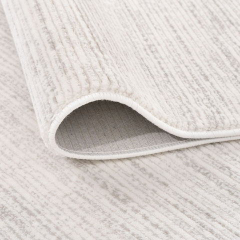 A soft off-white and gray striped rug with a ribbed textured surface perfect for cozy home spaces