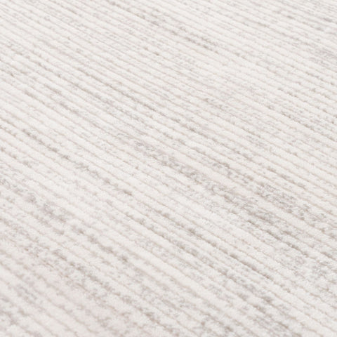 White textured fabric with a subtle diagonal ribbed pattern on the carmel cream-grey striped rug 6010