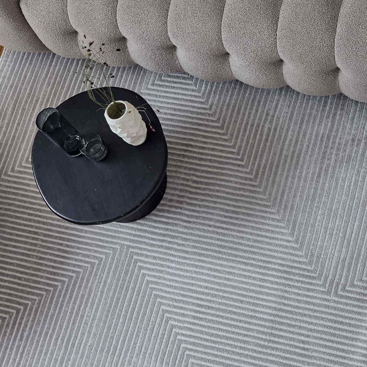 Gray geometric rug with cream accents featuring a textured woven surface perfect for living rooms or bedrooms