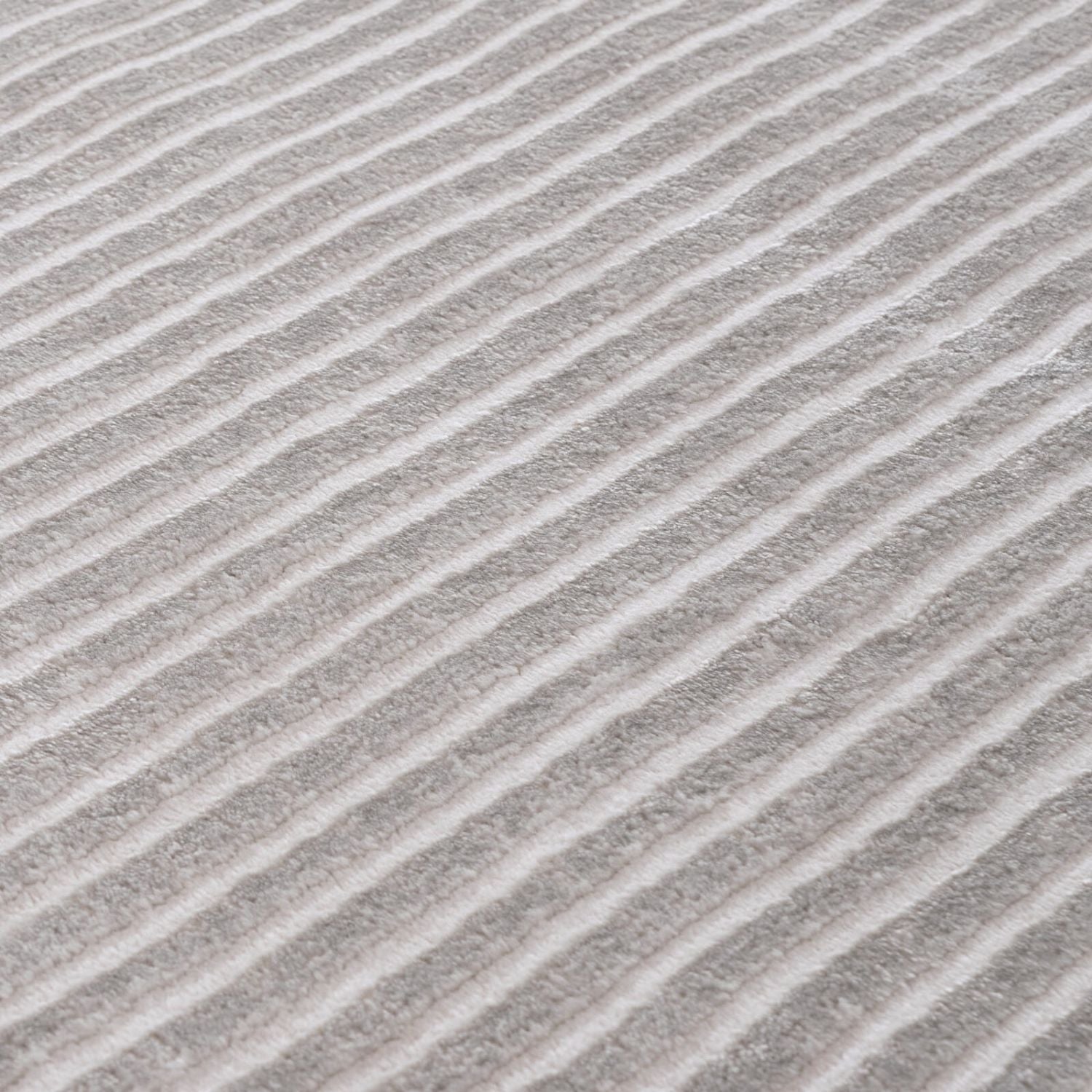 Carmel grey-cream geometric rug featuring gray and white diagonal stripes with a soft textured surface