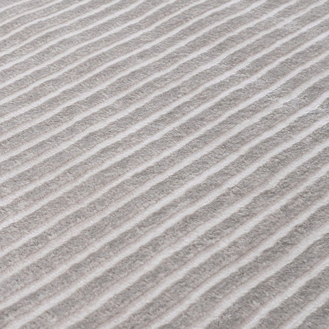 Carmel grey-cream geometric rug featuring gray and white diagonal stripes with a soft textured surface