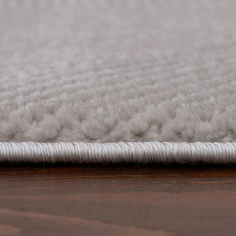 Soft white plush carpet with tightly woven edge on carmel grey rug abstract perfect for cozy modern spaces