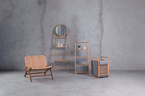 Woven rattan chair with wooden frame shown next to carrick 3 tier storage unit with grey fabric shelves