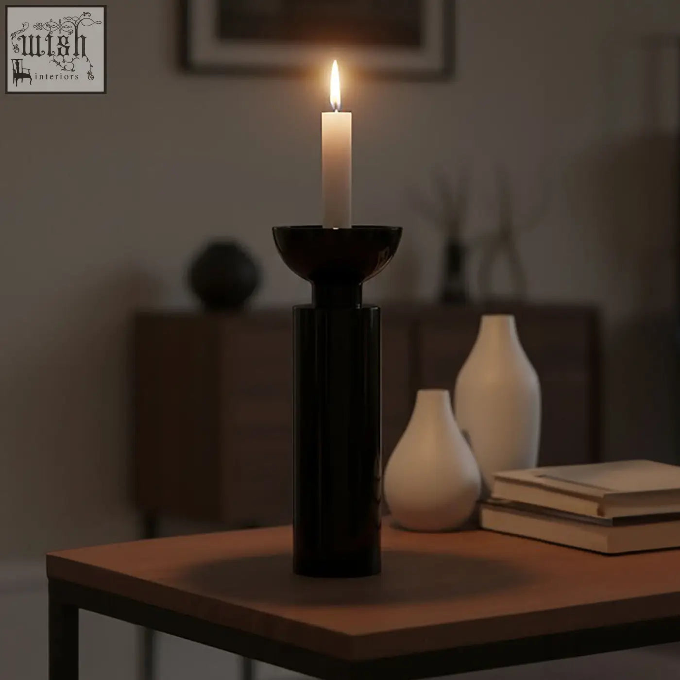 Large black crystal candle holder in sleek black ceramic holding a lit white candle for modern decor