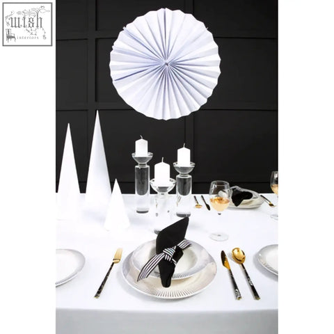 White paper fan hanging above the table with a carrie small crystal candle holder showcasing a sparkling crystal candle holder