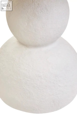 White papier mache table lamp shaped like a textured snowman figurine with a matte finish for cozy decor