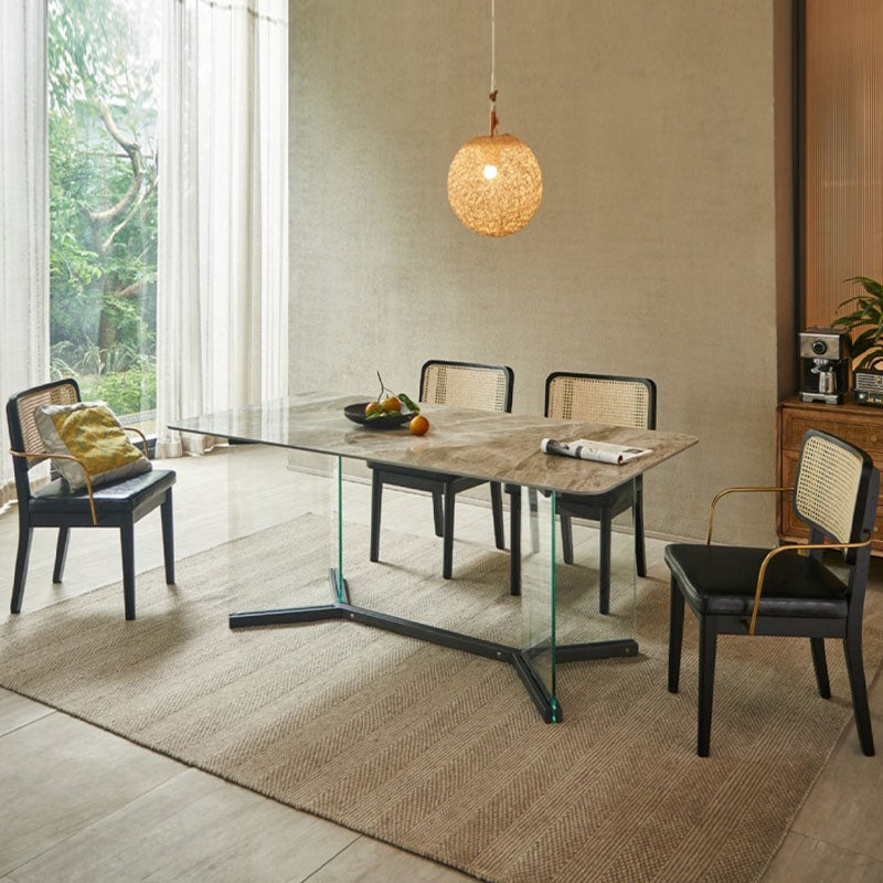 Modern glass-top dining table with marble surface and black metal base paired with cassie black dining chair