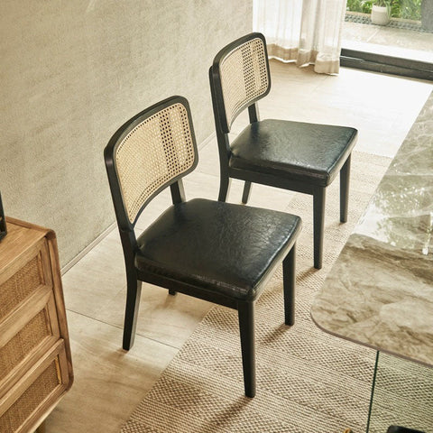 Cassie black dining chair with black leather upholstery and woven cane back perfect for stylish dining rooms