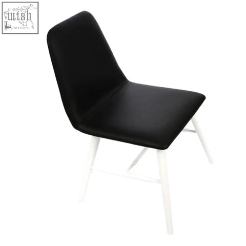 Black cassy leather effect dining chair with white legs and sleek upholstered seat perfect for any dining room