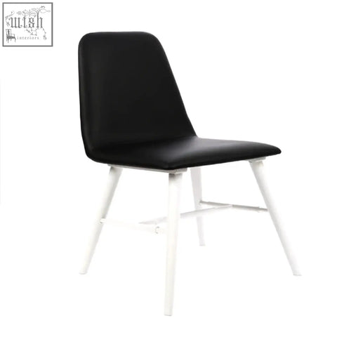 Cassy black leather dining chair with white legs and black upholstered seat for stylish dining spaces