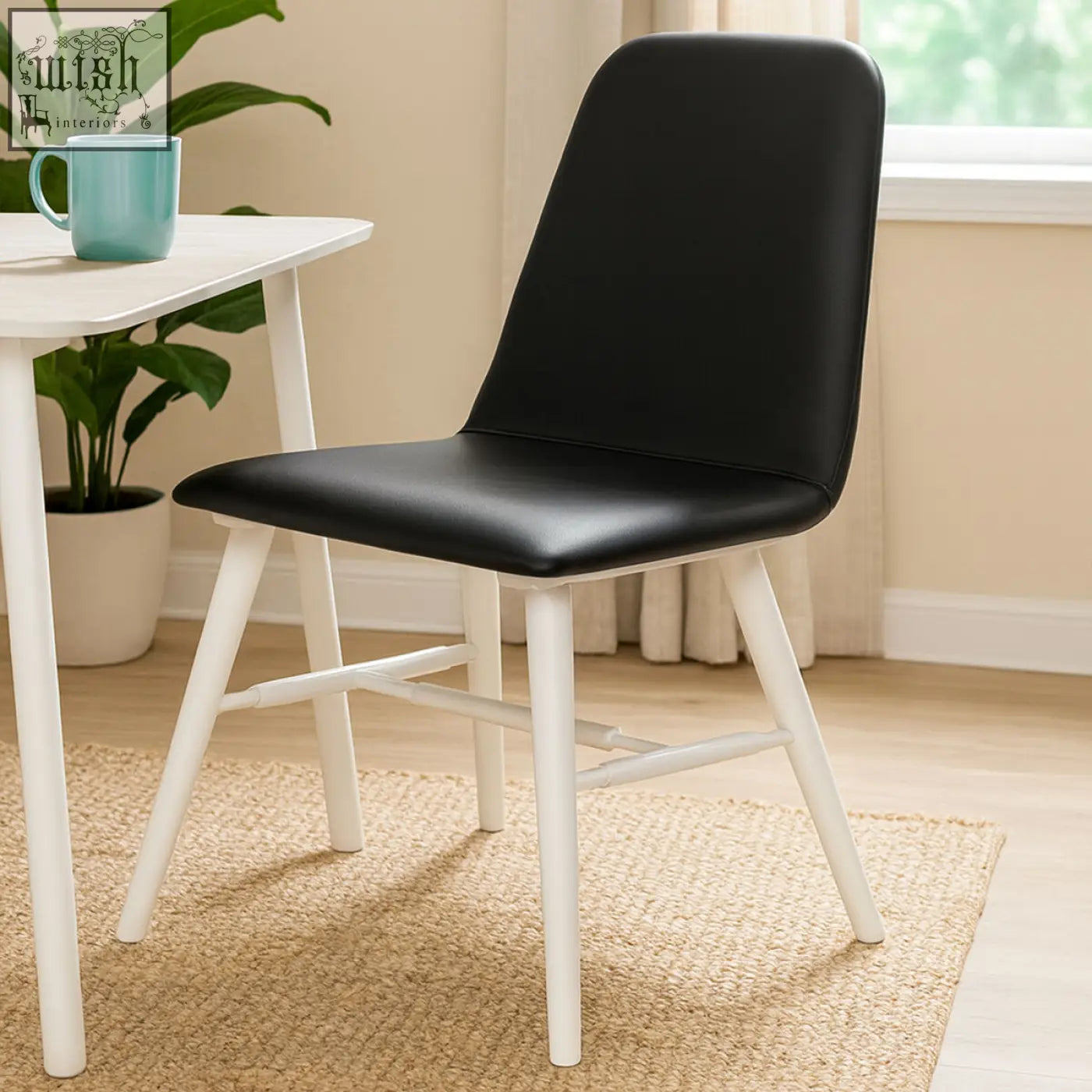 Cassy black leather dining chair with white legs featuring a sleek black faux leather seat and sturdy white wooden legs