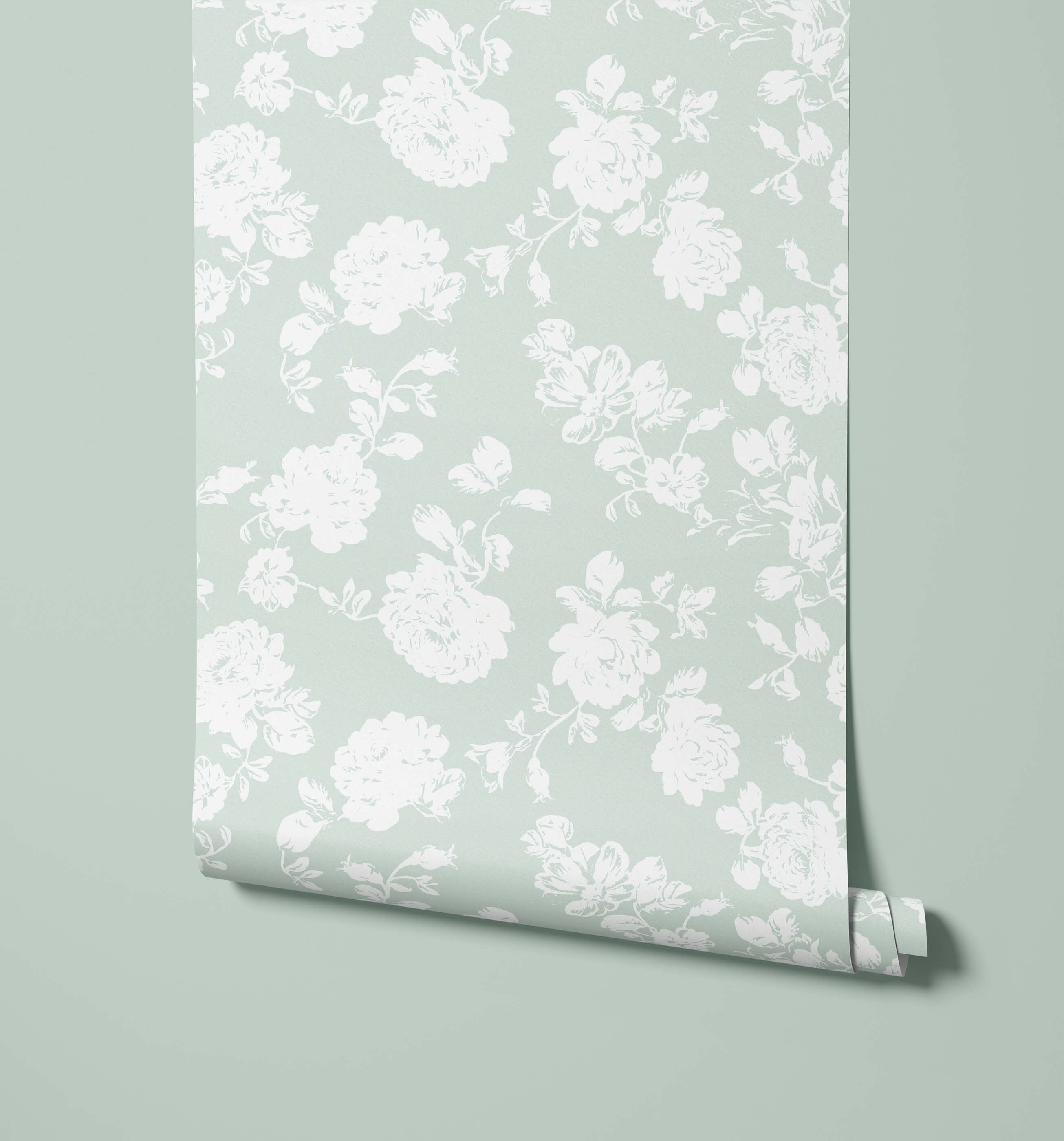A roll of pale mint green cast wallpaper with an elegant white floral pattern perfect for stylish walls