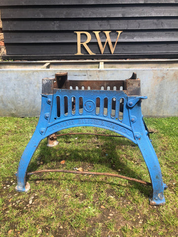 Blue cast iron fire grate with rusted bars and engraved branding for reclaimed original henry bamford table base