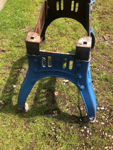 Blue painted cast iron stool with rusted accents featuring vintage henry bamford industrial table base design