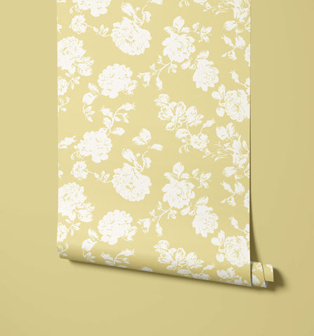 A roll of cast wallpaper in pale yellow with a delicate white floral pattern for stylish wall decor