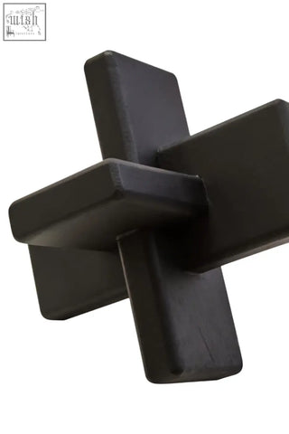 Black wood sculpture cato black featuring a sleek black plastic cross shaped puzzle piece design