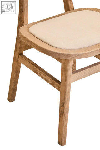 Light oak grey wash elm wood dining chair with a beige fabric upholstered seat perfect for dining rooms