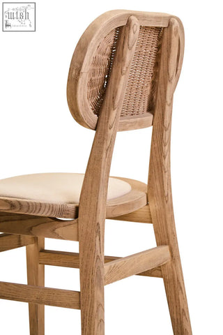 Rustic dining chair with grey wash elm wood frame, woven cane backrest, and beige fabric seat for dining room