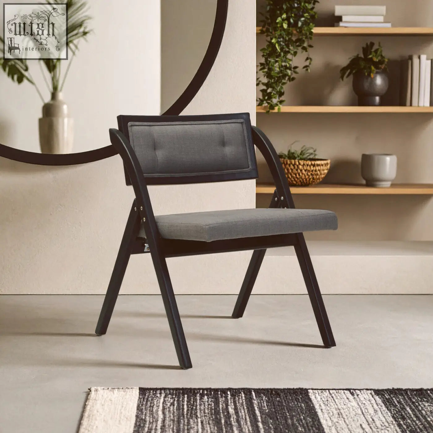 Modern black-framed folding chair with gray upholstered seat and backrest made of black elm wood