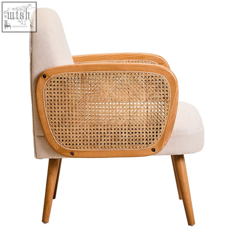 Beige upholstered armchair with woven cane back and elm wood legs offering comfortable seating in ivory fabric