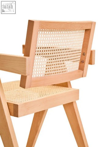 Light-colored cebu natural cane dining chair with woven cane back and seat and minimalist beech wood frame