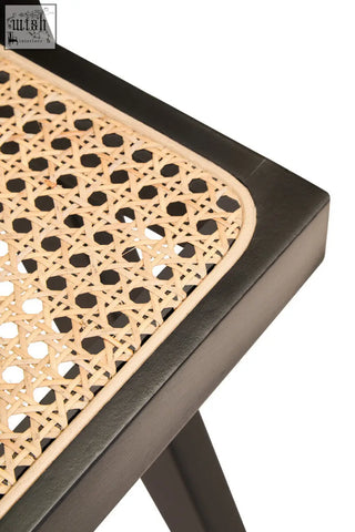 Black-framed cebu natural cane dining chair with woven light brown rattan seat and geometric pattern