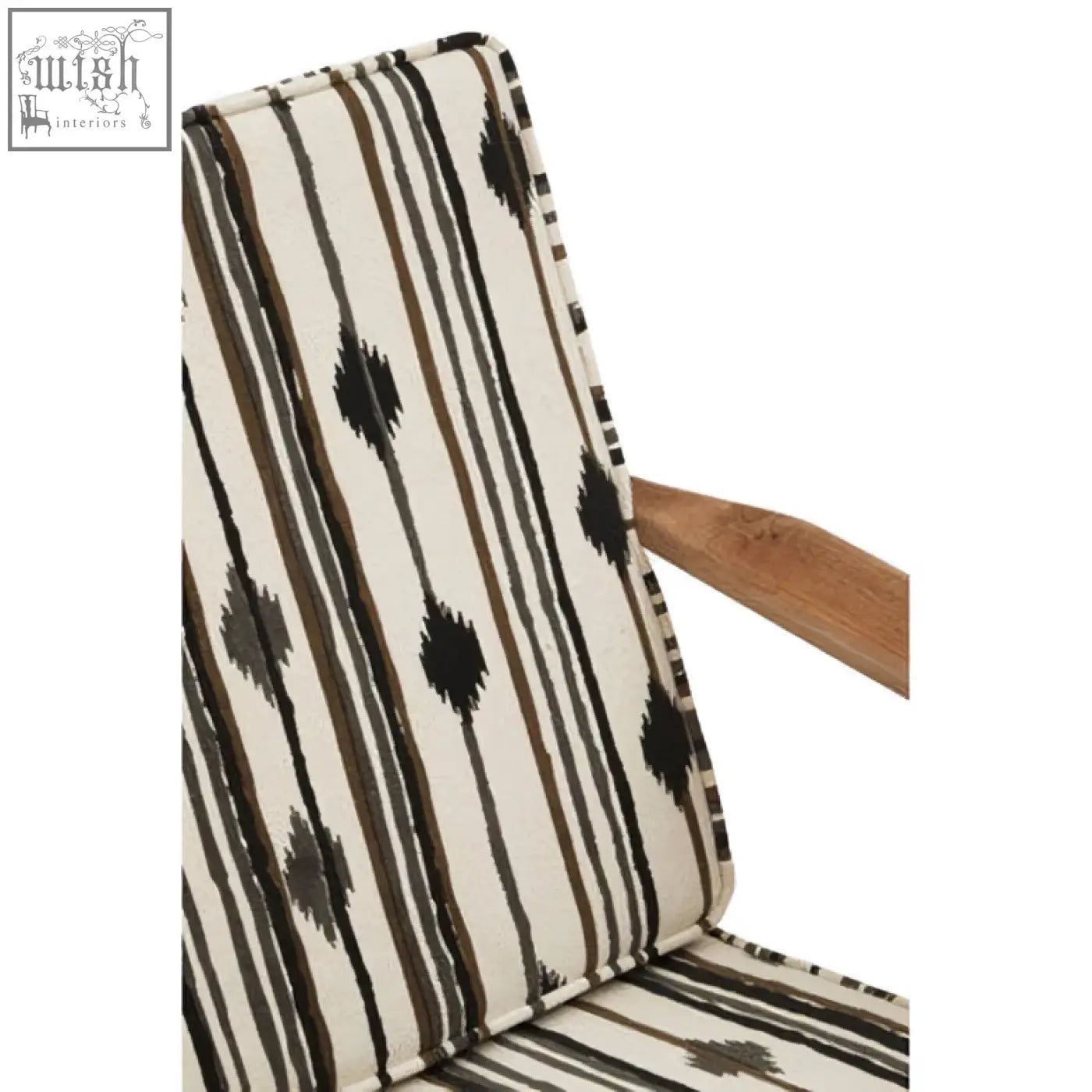 Back side of cefena armchair with angular arms cushioned in cream fabric with bold black stripes and white weave diamond motifs