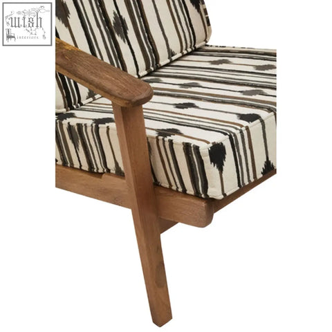 Cefena armchair with angular arms featuring a wooden frame and black and white striped patterned surface upholstery
