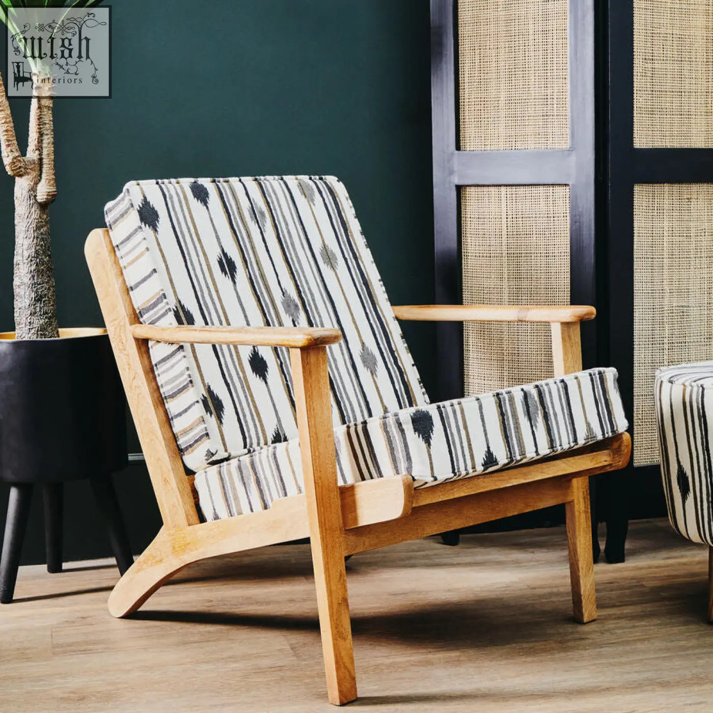 Cefenla armchair with angular arms featuring a light wood frame and black white gray striped patterned surface upholstery