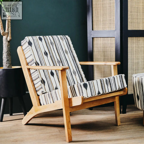Cefenla armchair with angular arms featuring a light wood frame and black white gray striped patterned surface upholstery