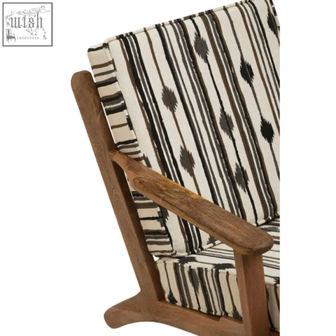 The cefena armchair features angular arms and black and white striped white weave upholstery with an ikat pattern