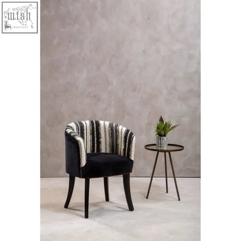 Black upholstered cefena chair with white striped backrest nailhead trim and mango wood legs adds depth to any room