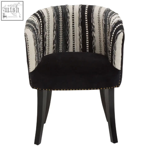 Cefena black and white chair with black velvet armrest, white striped fabric, and mango wood legs adds depth to any space