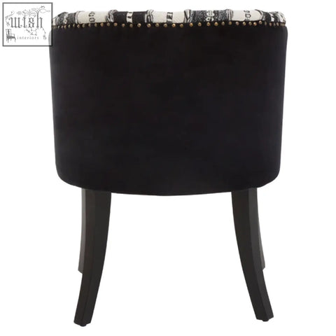 Black velvet stool with decorative patterned trim and studded edge adds depth to the cefena black and white chair