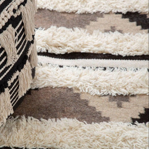 Cefena black pouffe black and cream striped pouf with tassels perfect for cozy living spaces