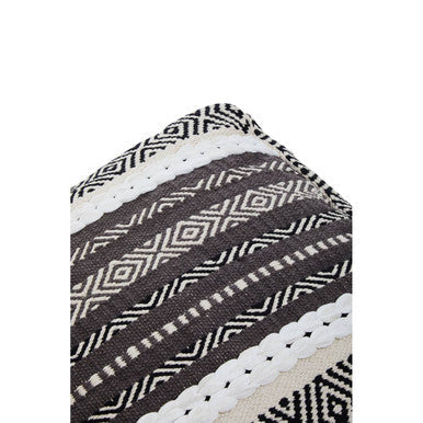 Black and white geometric patterned woven textile on the cefena grey and white pouffe with textured layered design