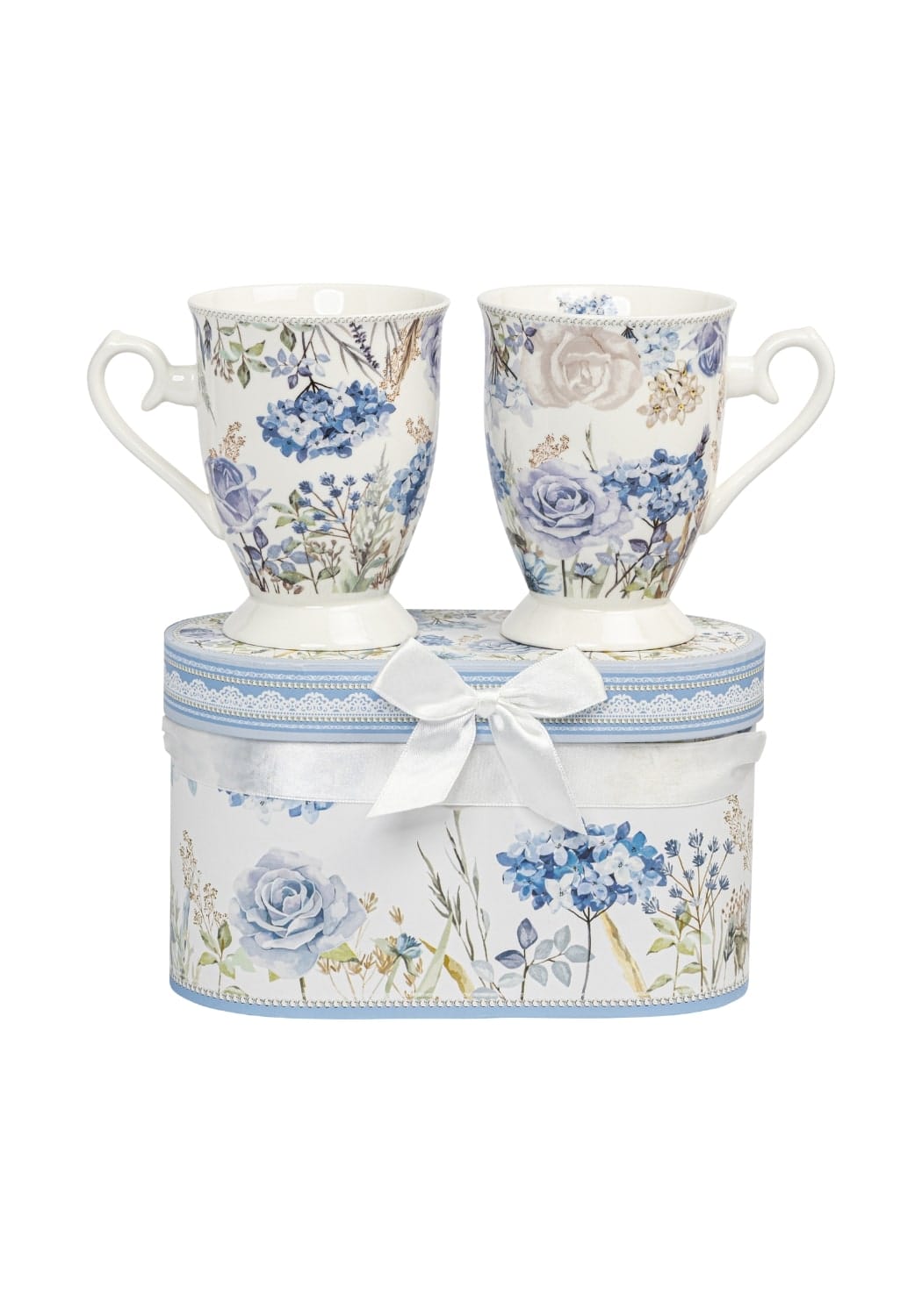 A delicate porcelain tea set with two blue and white floral mugs in a lace trimmed gift box with satin bow