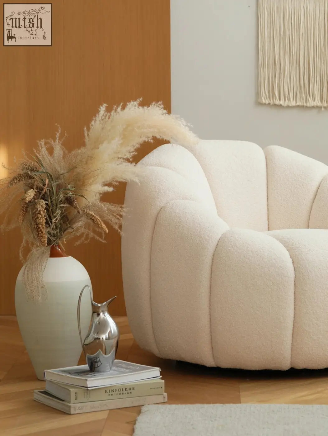 Cream-colored plush pumpkin round armchair with segmented white boucle fabric and modern sculptural design