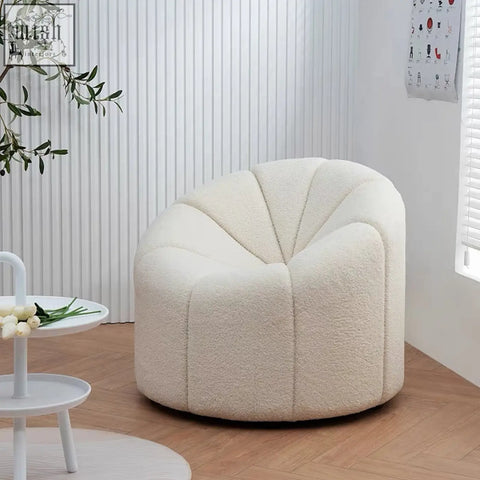 Cream-colored pumpkin round armchair with plush shell shape and soft white boucle fabric finish