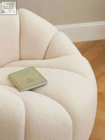 Cream-colored pumpkin round armchair with plush shell shape and soft white boucle fabric finish