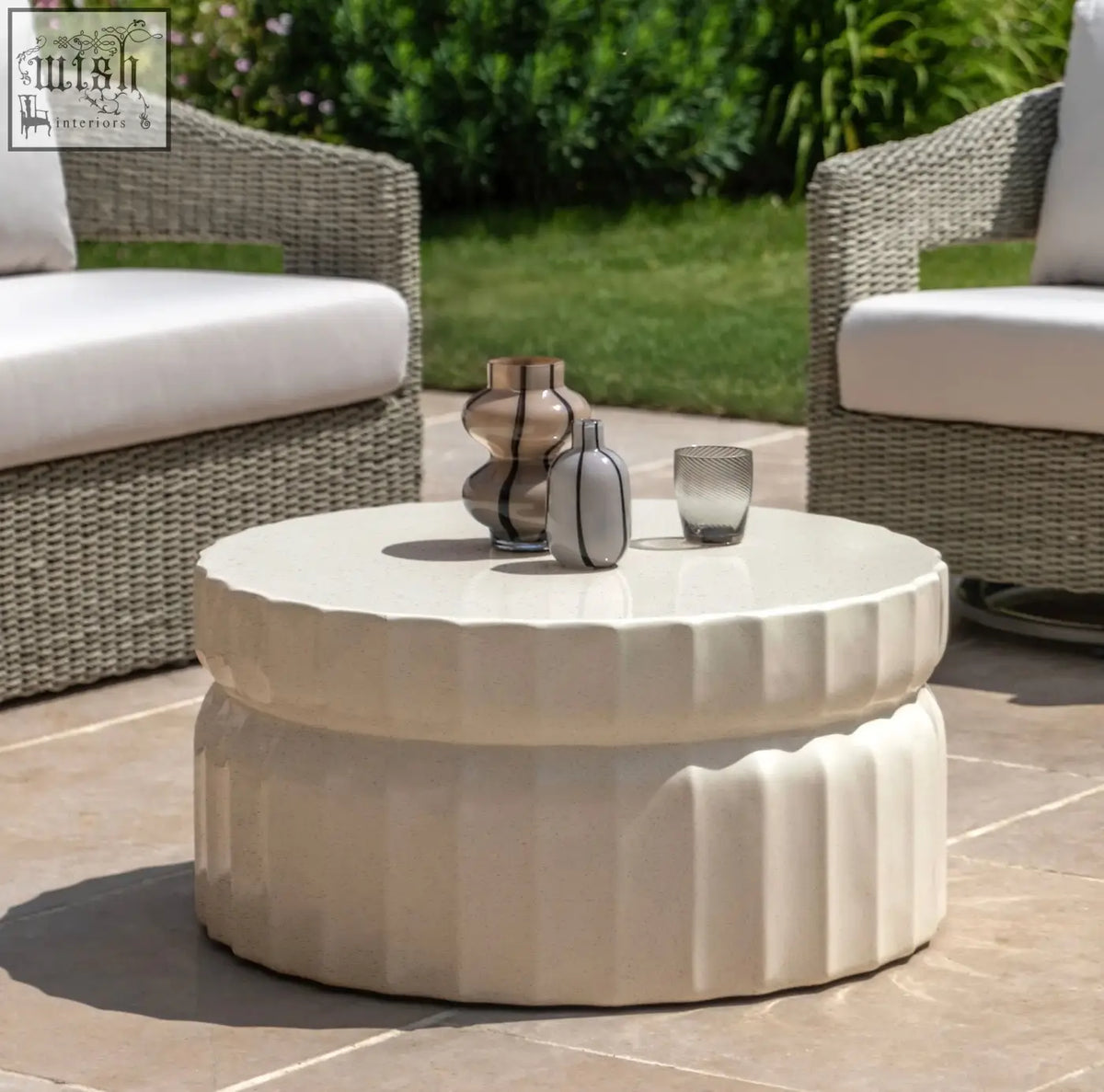 Creamo-colored celino coffee table with fluted concrete base and smooth cream glazed surface top coffee table features