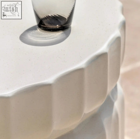 Celino coffee table with a sleek off-white ceramic scalloped edge and subtle cream glazed surface texture