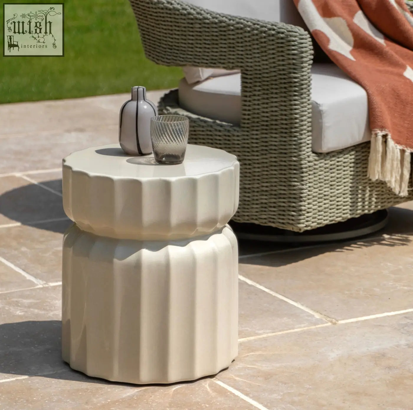 Cream-colored ceramic celino side table with a modern ridge pattern and fluted stacked design