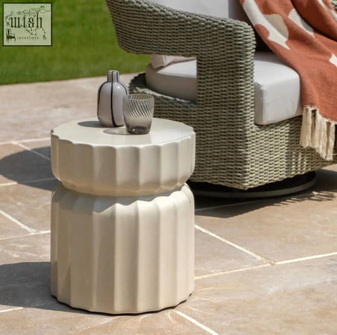 Cream-colored ceramic celino side table with a modern ridge pattern and fluted stacked design