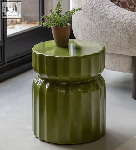 Celino side table in olive green ceramic with modern ridge pattern and glossy green glazed finish for stylish spaces