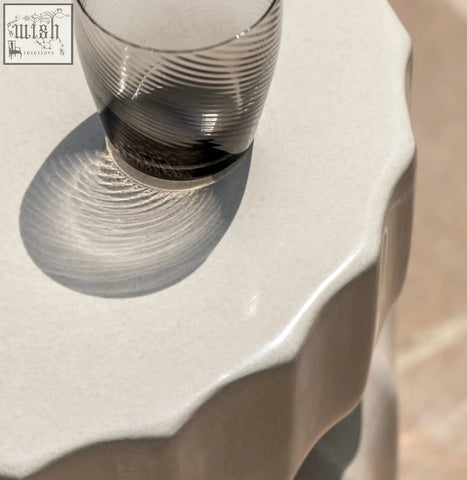 Celino side table with a translucent gray glass tumbler featuring a modern ridge pattern and subtle concentric ridges